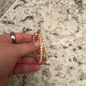 Tatum James Gold hoops with white accents.